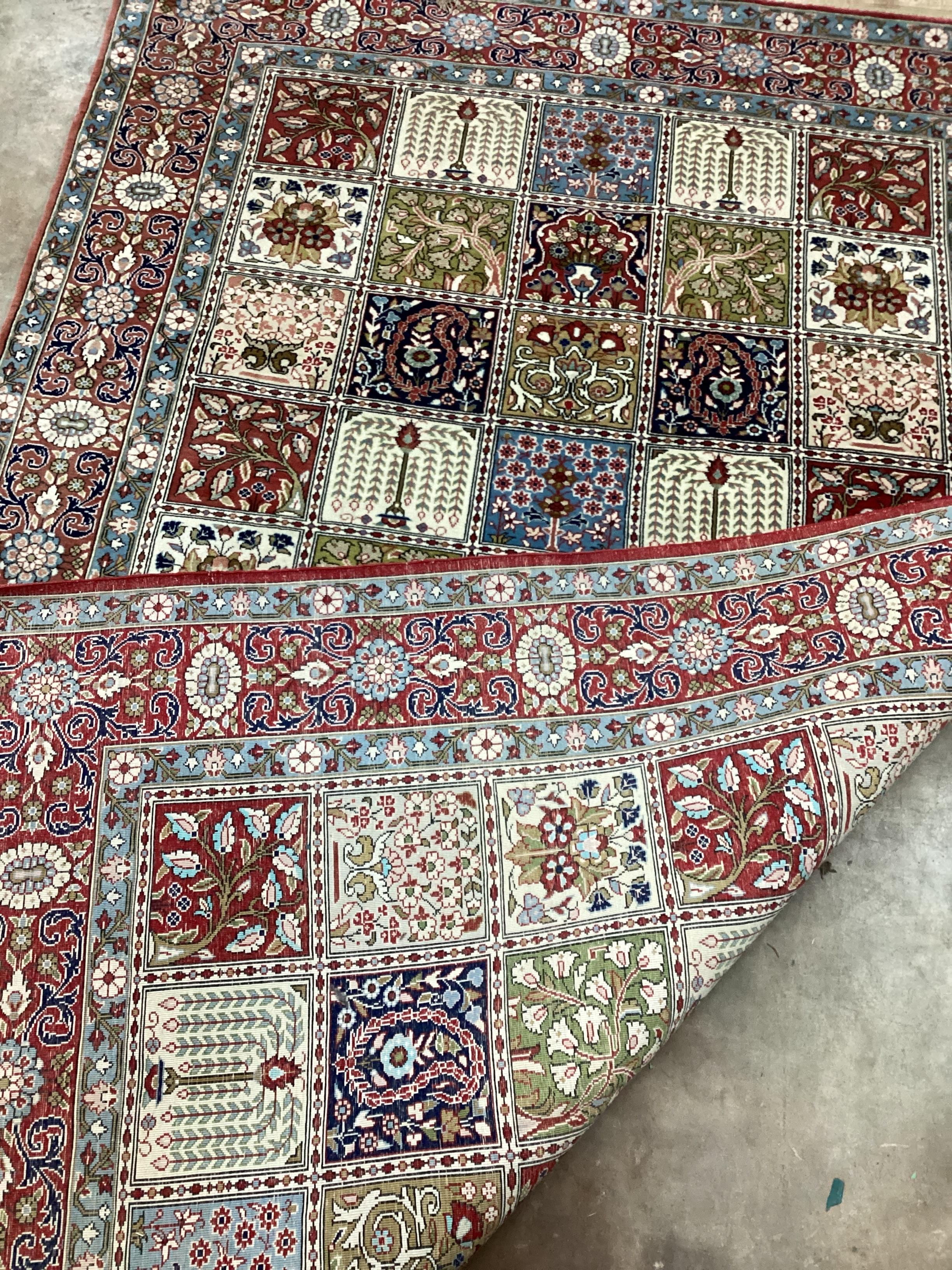 A Baktiari cream ground rug with divided field and triple border, 215 x 136cm